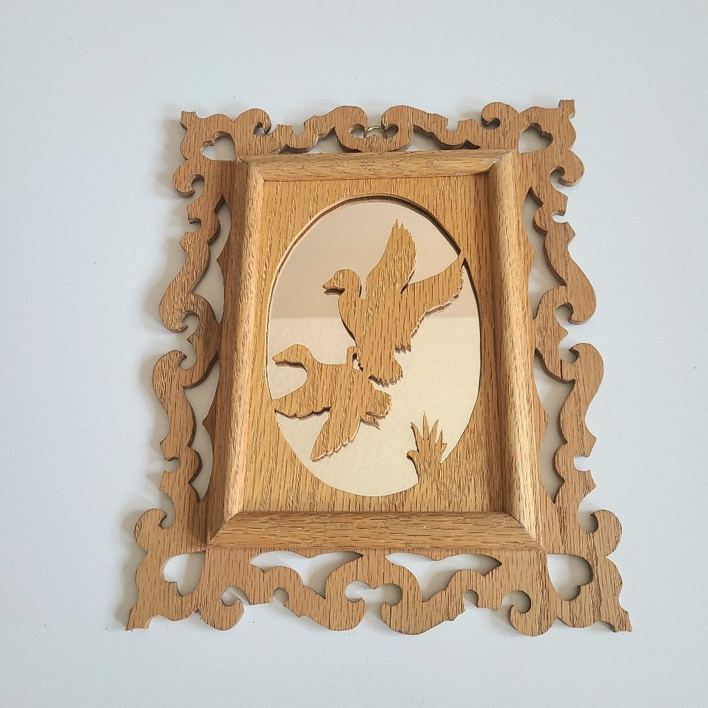 Vintage mirror in wooden handmade frame with birds.